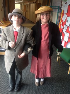 Children from St Marks School trying on dressing up clothes from the Education Packs handling boxes | Ali Kay