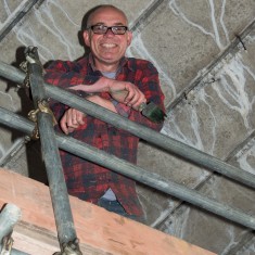 Principal mural artist Fred Fieber takes a breather during painting of the Jubilee Mural | John Palmer