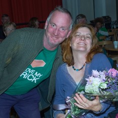 Mosaic artist Joanna is presented with a bouquet to thank her for all of her hard work, by Finbarr (project volunteer) | John Palmer