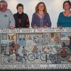 Pat Shelley of Salisbury and Stonehenge Tours who gave some money towards the mosaic; Mary Stephens (Treasurer); Joanna Dewfall (Mosaic Artist) and Clare Christopher (Project Co-ordinator) behind the newly unveiled mosaic. | John Palmer