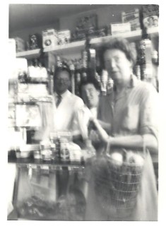 Inside the shop in the 1950s with Mr. Ralph and his shop assistant Brenda. Mr. Ralph's son David thinks the customer may have been Mrs. Izzard of Culver Street. | David Ralph