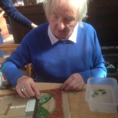 Day 2 of making the Greencroft Street Mosaic, 30th September 2017. Jan Truckle grew up on Greencroft Street and remembers having an outside loo, shared with other houses. We added that to the design and here she is adding some tiles!