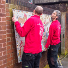 Nathan and Jonathan from T-signs getting the mosaic in place on the morning before the unveiling. | John Palmer